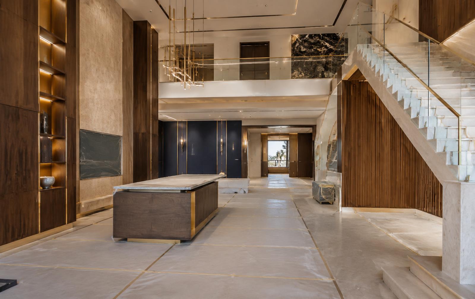 Luxury UAE villa fit-out with refined walnut, stone and muted gold details