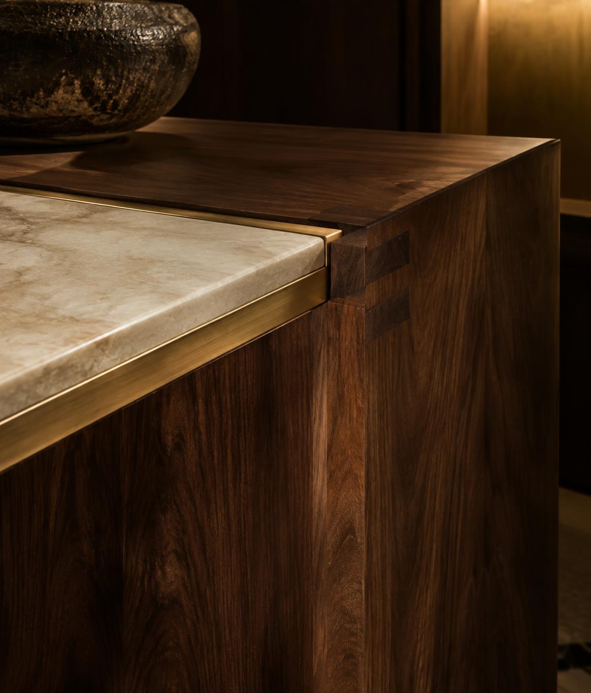 Hand-finished walnut joinery with stone and brass detailing